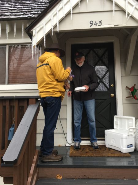 Photo of person delivering a meal to recipient